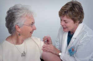 Physician Vaccinating Older Patient