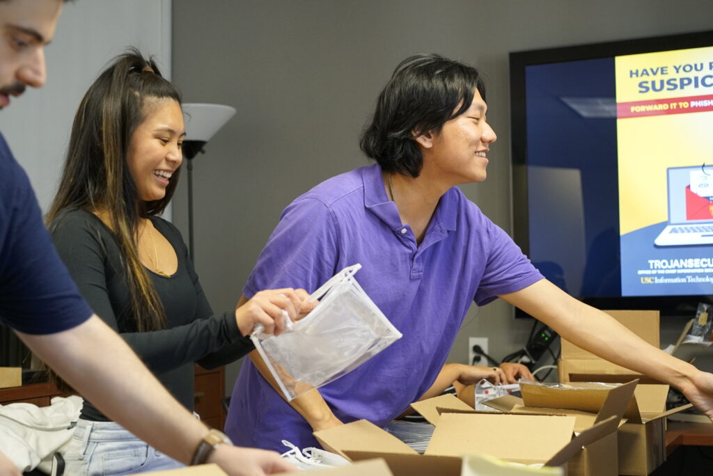 Members of NaloxoneSC, an initiative of the USC Student Chapter of the American Association of Psychiatric Pharmacists (AAPP-USC), prepare kits to distribute to USC students. (Photo by Isaac Mora / USC Mann)