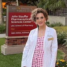 Yasi Mojab outside on the USC Pharmacy campus in white lab coat