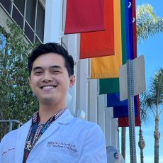 Tam Phan, assistant professor of clinical pharmacy at USC Mann School of Pharmacy and Pharmaceutical Sciences, standing in front of the Los Angeles LGBT Center.